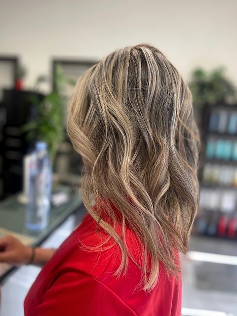 Shoulder-length hair with dimensional blonde highlights and soft waves