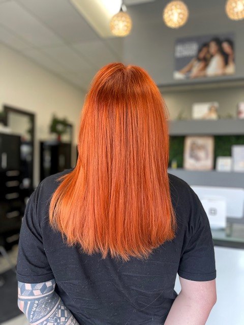 Long straight hair in an all-over bright copper